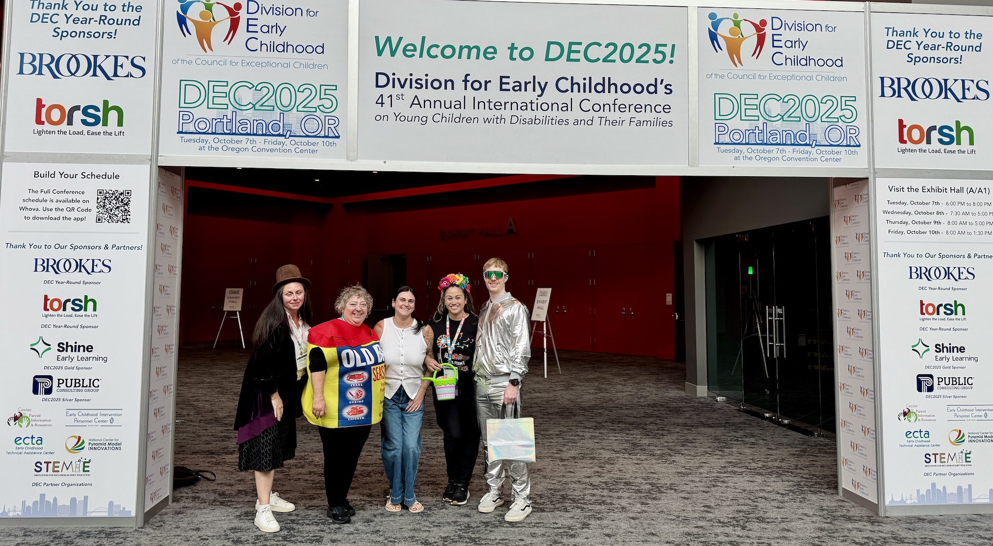 VEIPD team standing underneath DEC archway
